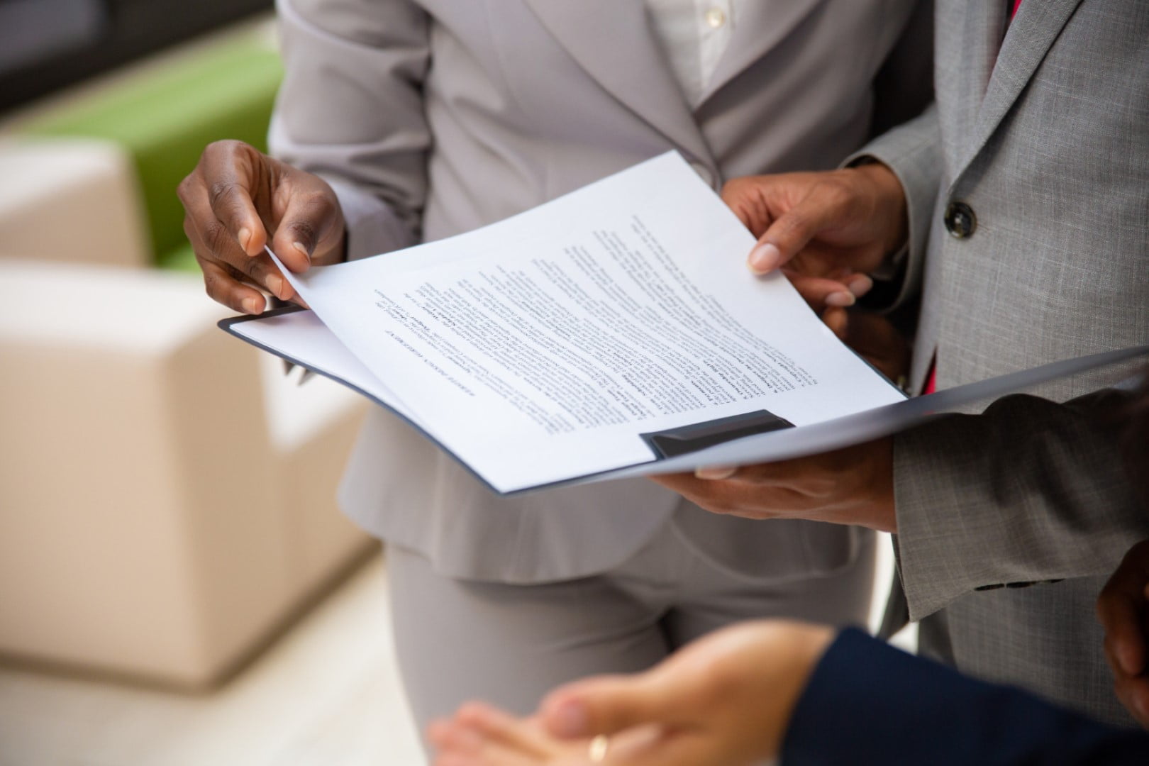 diverse business partners reading contract together Large